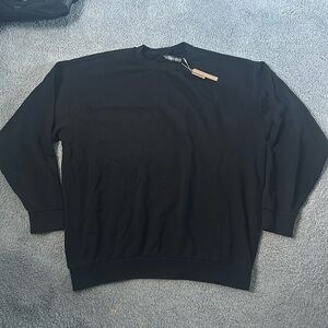 Skims XL Terry Fleece Crewneck in the color “washed obsidian” (black).